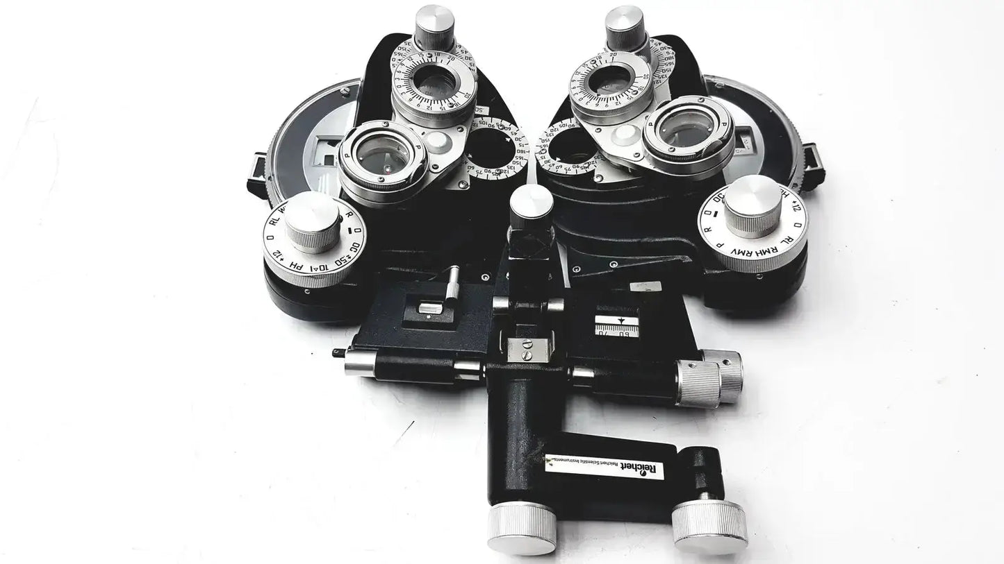 Black and silver Reichert 11625 minus cylinder phoropter refracting instrument with adjustable lenses and some damage