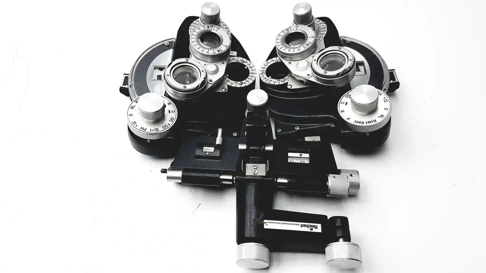 Black and silver Reichert 11625 minus cylinder phoropter refracting instrument with adjustable lenses and some damage