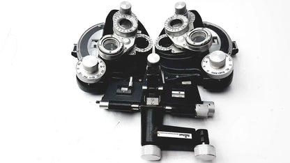 Black and silver Reichert 11625 minus cylinder phoropter refracting instrument with adjustable lenses and some damage