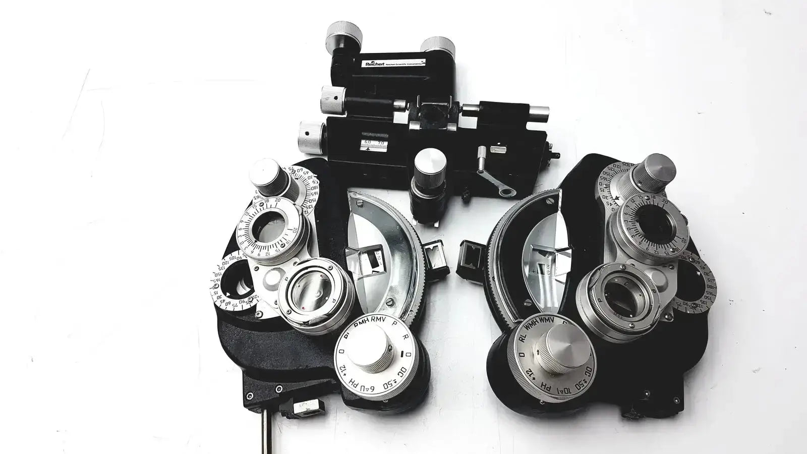 Black and silver Reichert 11625 minus cylinder phoropter refracting instrument with adjustable lenses and some damage