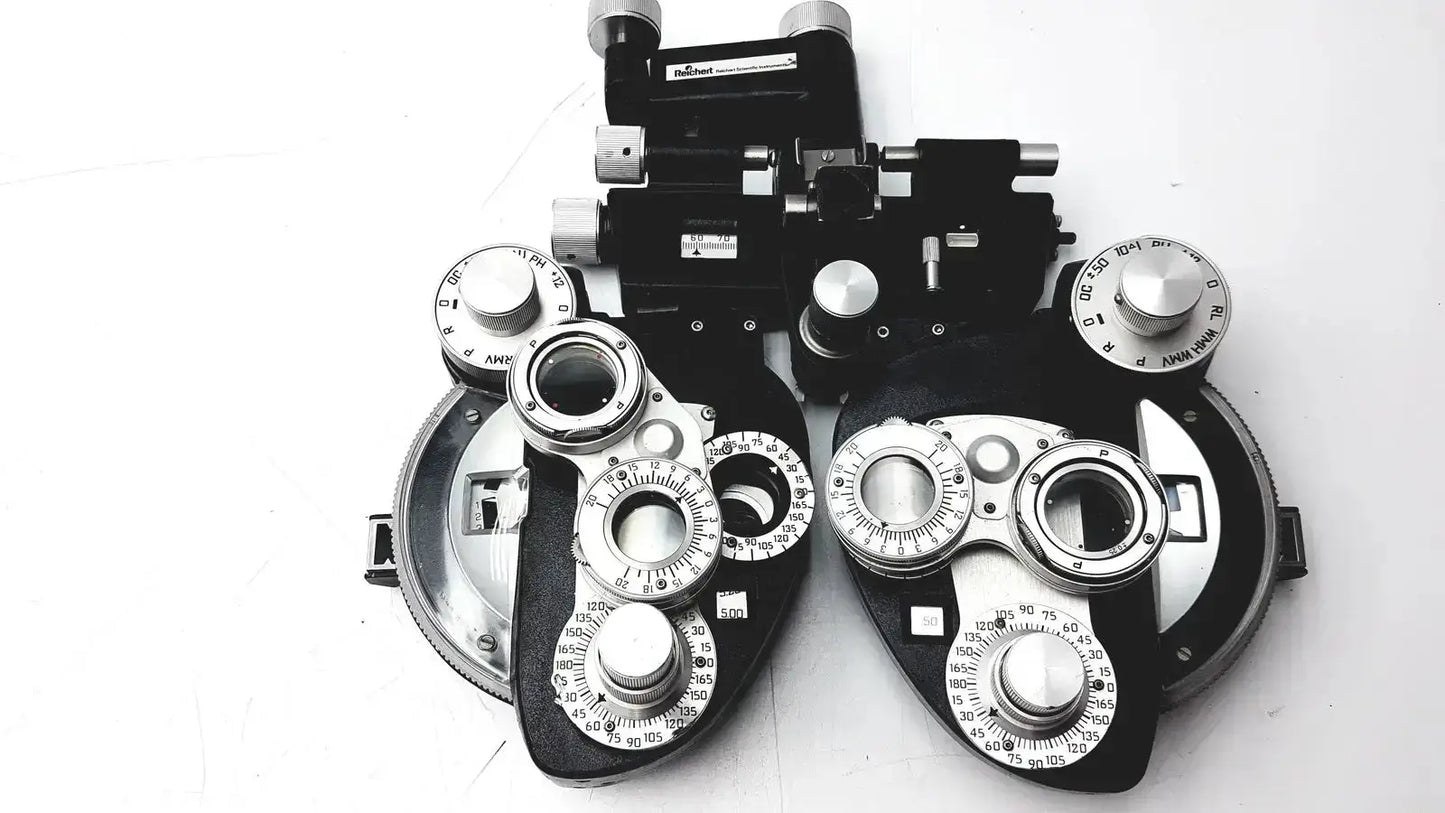 Black and silver Reichert 11625 minus cylinder phoropter refracting instrument with adjustable lenses and some damage