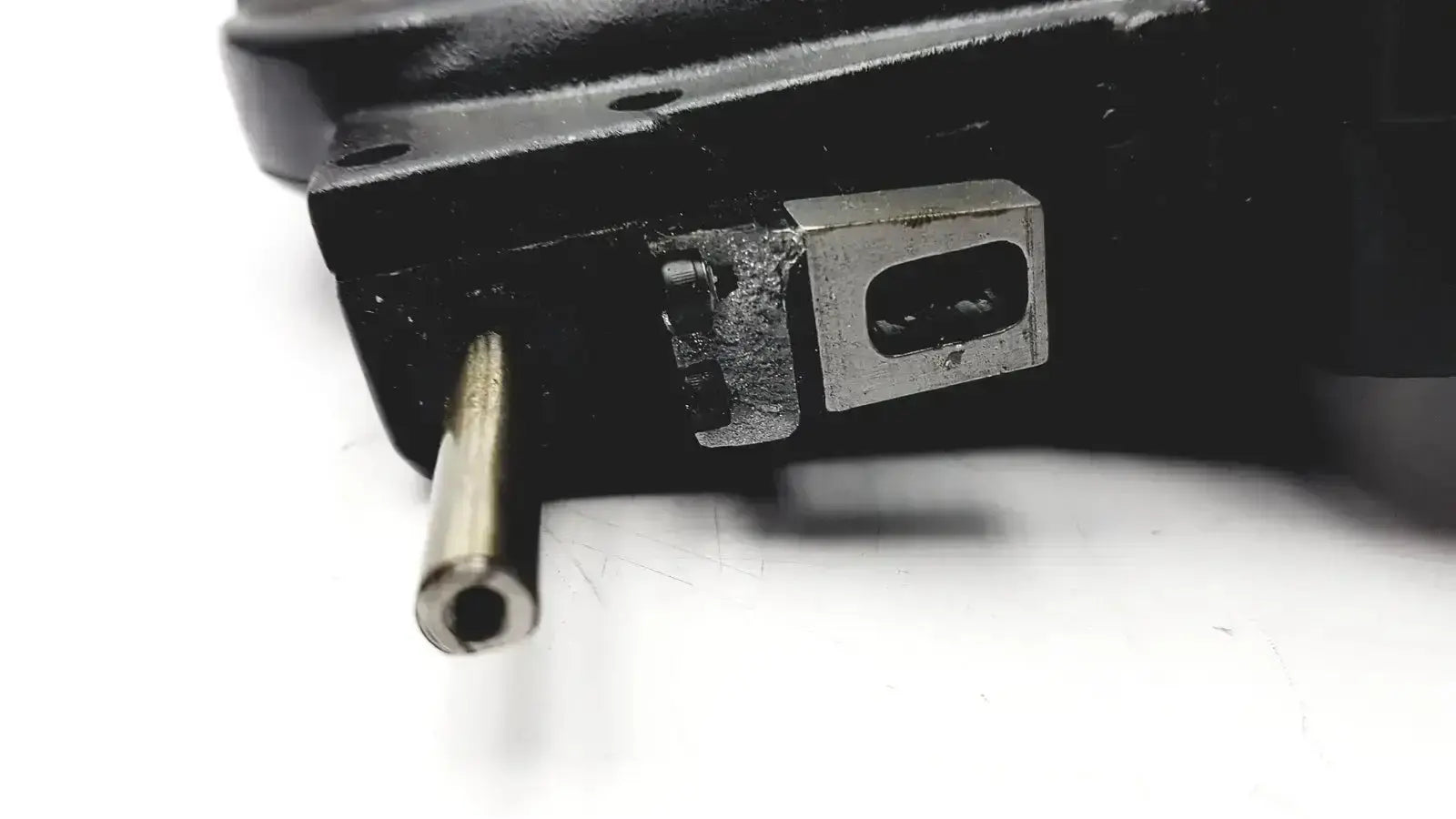 Black industrial minus cylinder phoropter with metallic silver accent and cylindrical shaft showing some damage