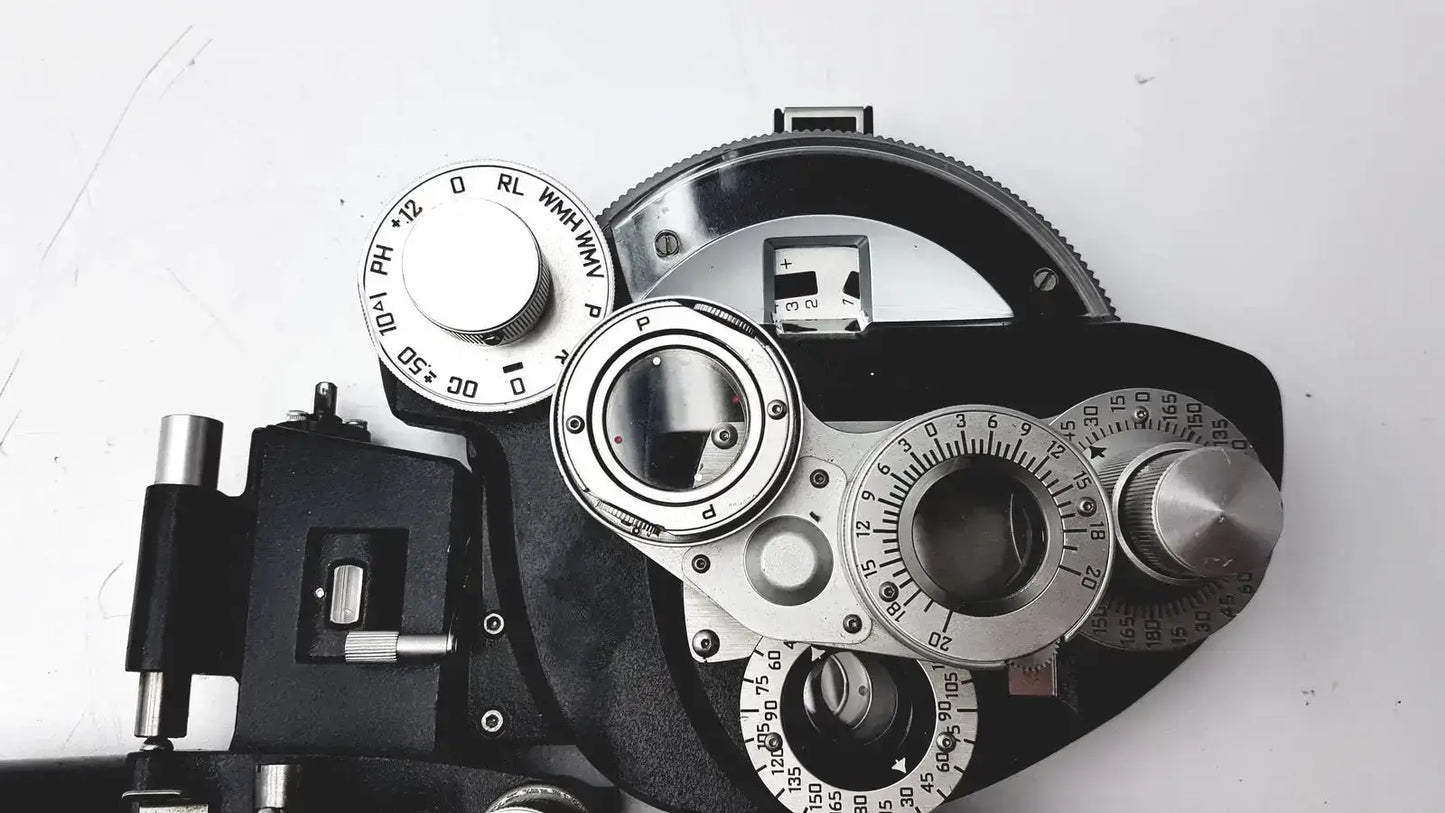 Silver and black automatic minus cylinder phoropter refracting instrument with adjustable dials for precise eye examination with some damage