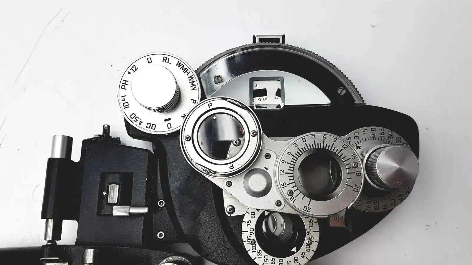 Silver and black automatic minus cylinder phoropter refracting instrument with adjustable dials for precise eye examination with some damage