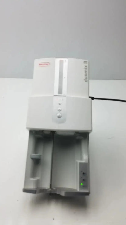 White plastic renfert duomix ii automatic dental impression scanner with vertical slot and control buttons for dental impression mixing