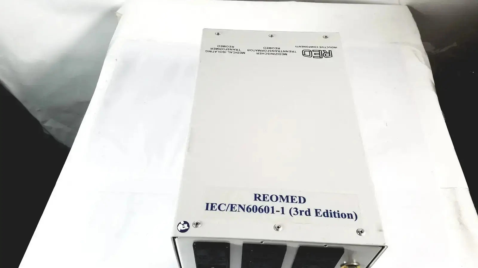 White rectangular reo reomed 600 medical isolating transformer 3rd edition with black ventilation slots and silver screws