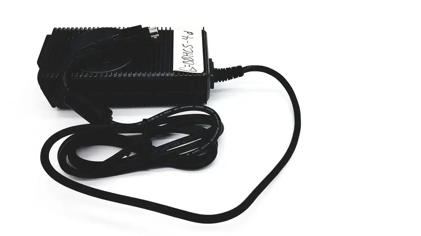 Black plastic respironics power charger with coiled black cable and white label for efficient power connection