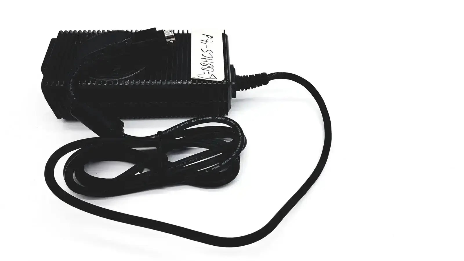 Black plastic respironics power charger with coiled black cable and white label for efficient power connection