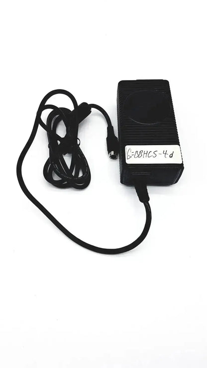 Black rectangular respironics power charger with coiled cable and white label bearing code g-88hcs-4d