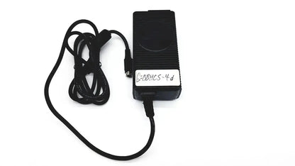 Black rectangular respironics power charger with coiled cable and white label featuring handwritten text