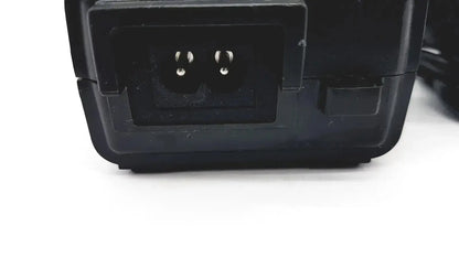 Black plastic respironics power charger with rectangular input port and two metal prongs for power connection