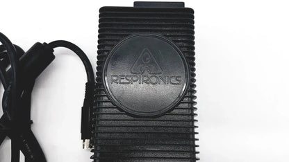 Black rectangular respironics power charger with ribbed texture and circular logo for oxygen concentrator use