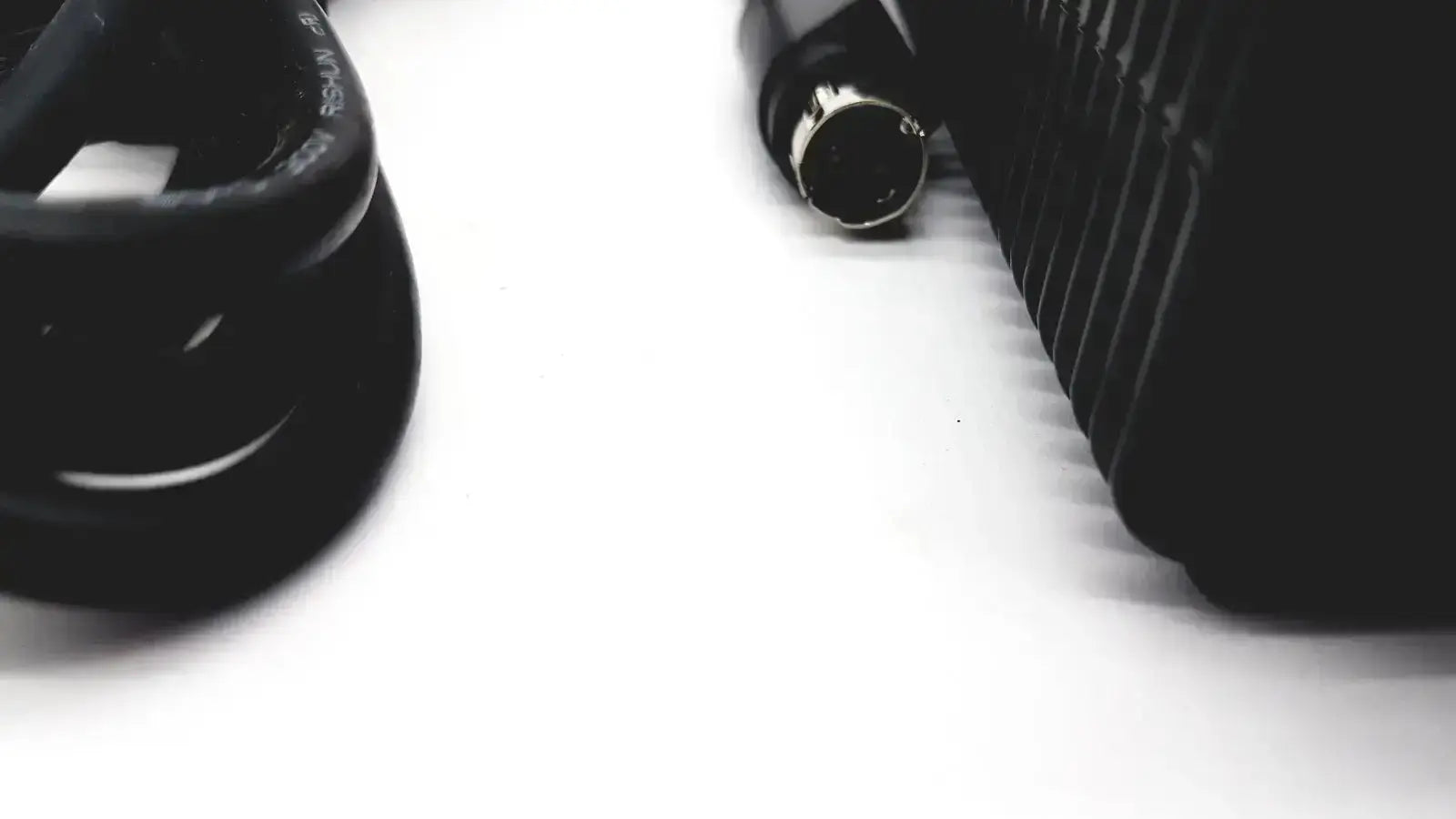 Black coiled cable with metallic connector end for respironics power charger providing reliable power connection