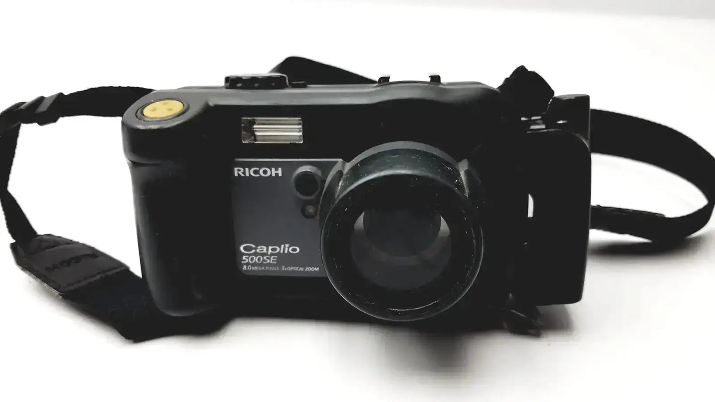 Black Ricoh Caplio 500SE digital camera with 8.0 mega pixels and yellow shutter button featuring 3x optical zoom digital lens