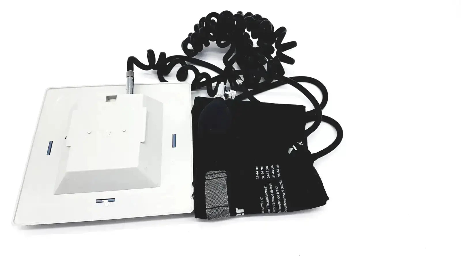White rectangular riester big ben square sphygmomanometer with coiled black tubing and inflatable adult cuff