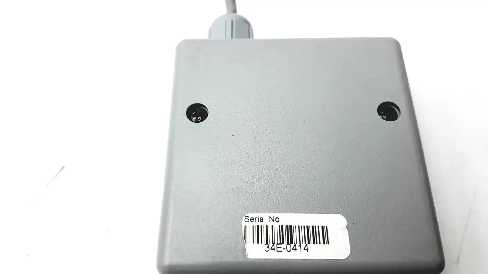 Gray rectangular rigel medical sp-sim adapter nellcor oximax with barcode label and two circular ports on top surface