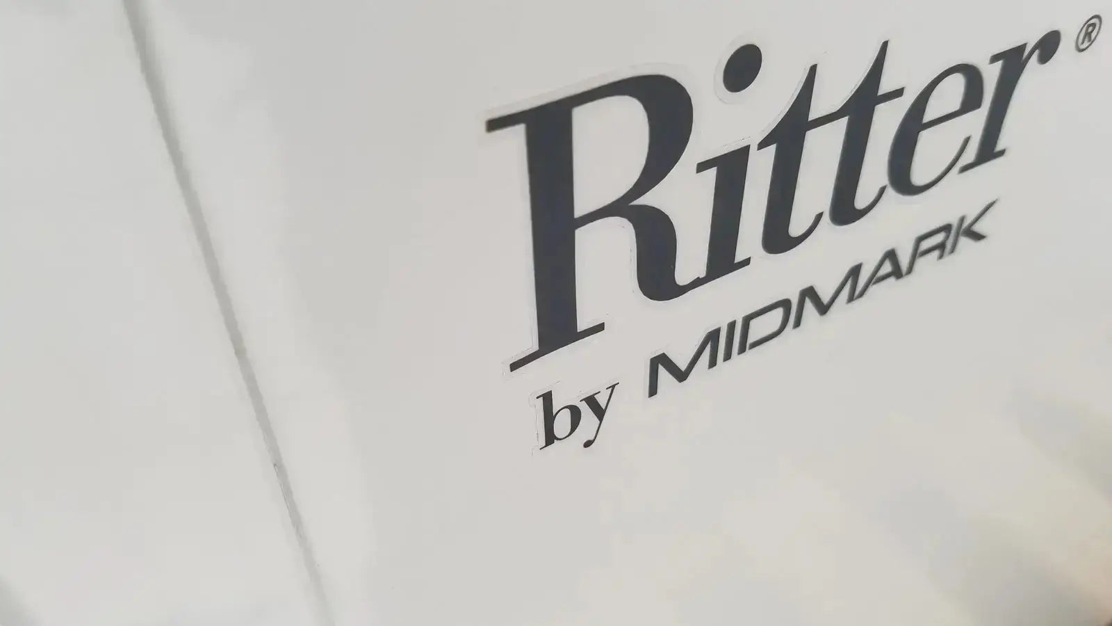 White Ritter by Midmark exam table label with black serif lettering for buy used medical equipment sale