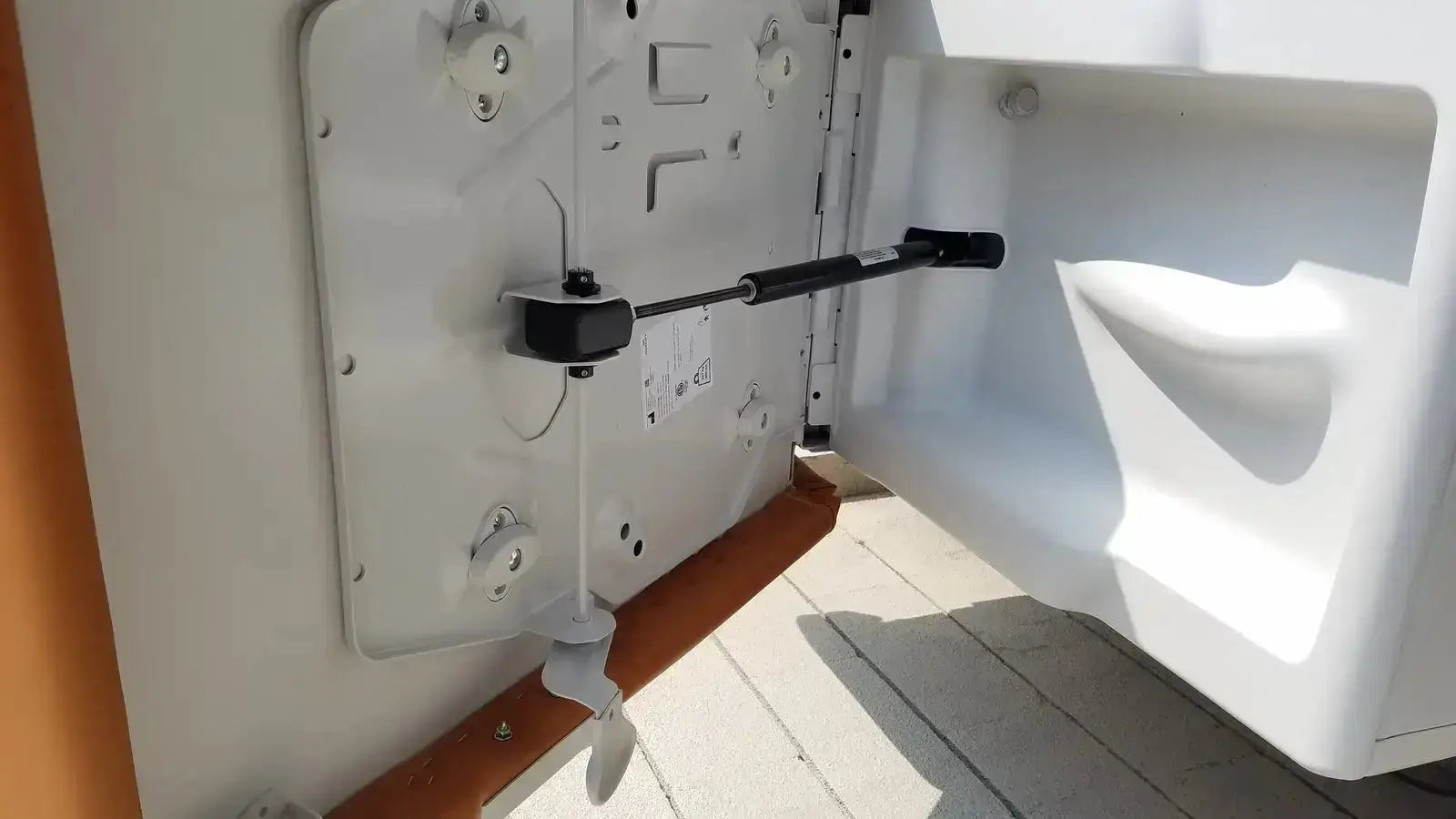 White plastic boat door with black metal latch and handle on ritter by midmark exam table model 204-011 buy used medical equipment