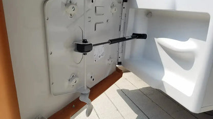 White plastic boat door with black metal latch and handle on ritter by midmark exam table model 204-011 buy used medical equipment
