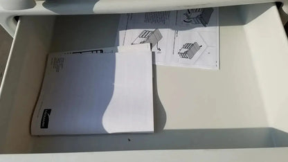 White plastic drawer containing instruction manuals and folded paper in ritter by midmark exam table model 204-011 used medical equipment for sale