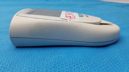 Beige plastic Roche CoaguChek S coagulation meter with small screen and sticker for reuse medical equipment use