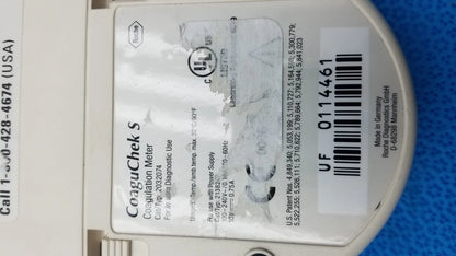 White Roche CoaguChek S coagulation meter with black labeling and barcode for reuse medical equipment applications