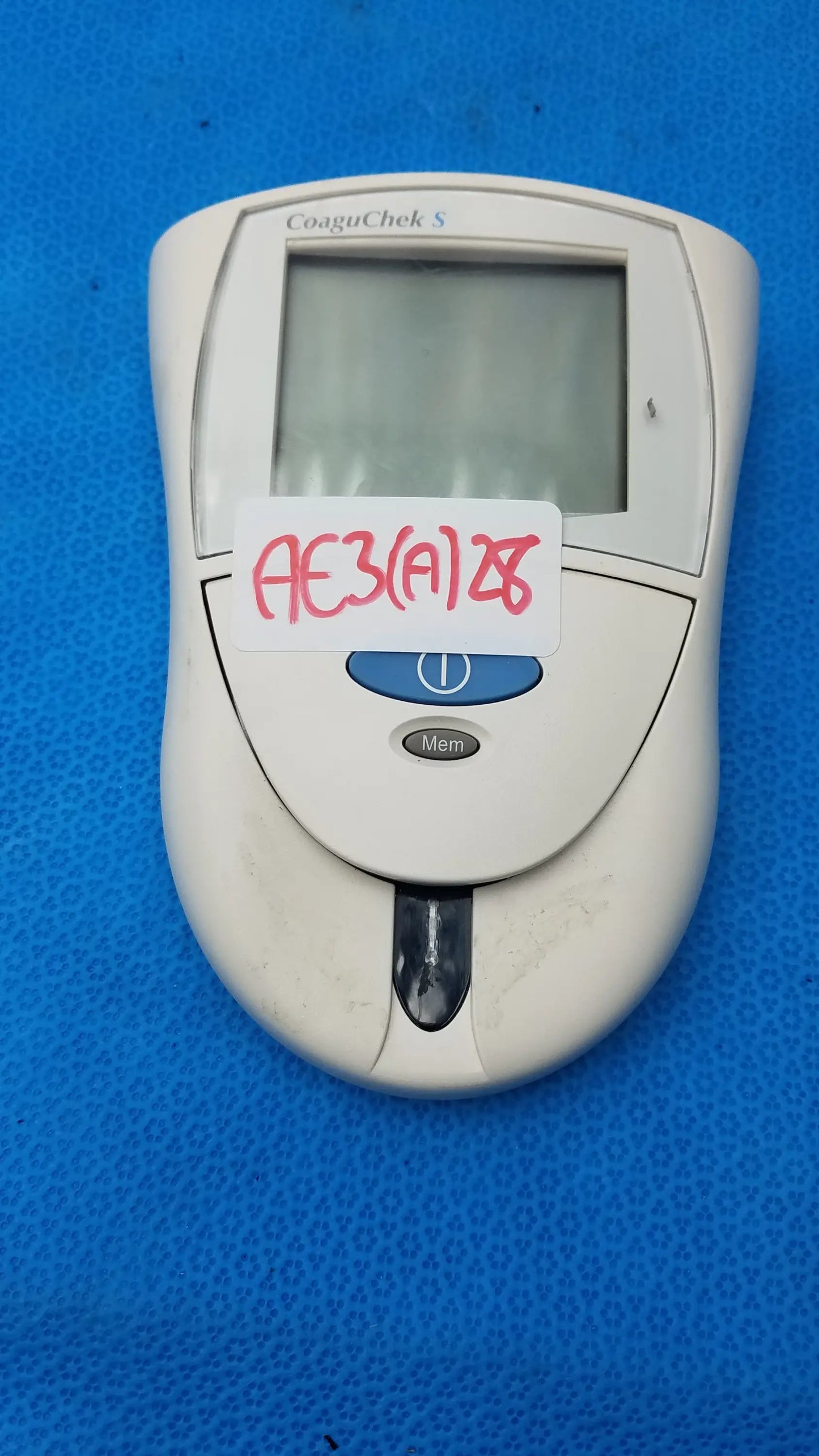 Roche CoaguChek S coagulation meter medical equipment with white body digital display and blue power button for reuse medical use