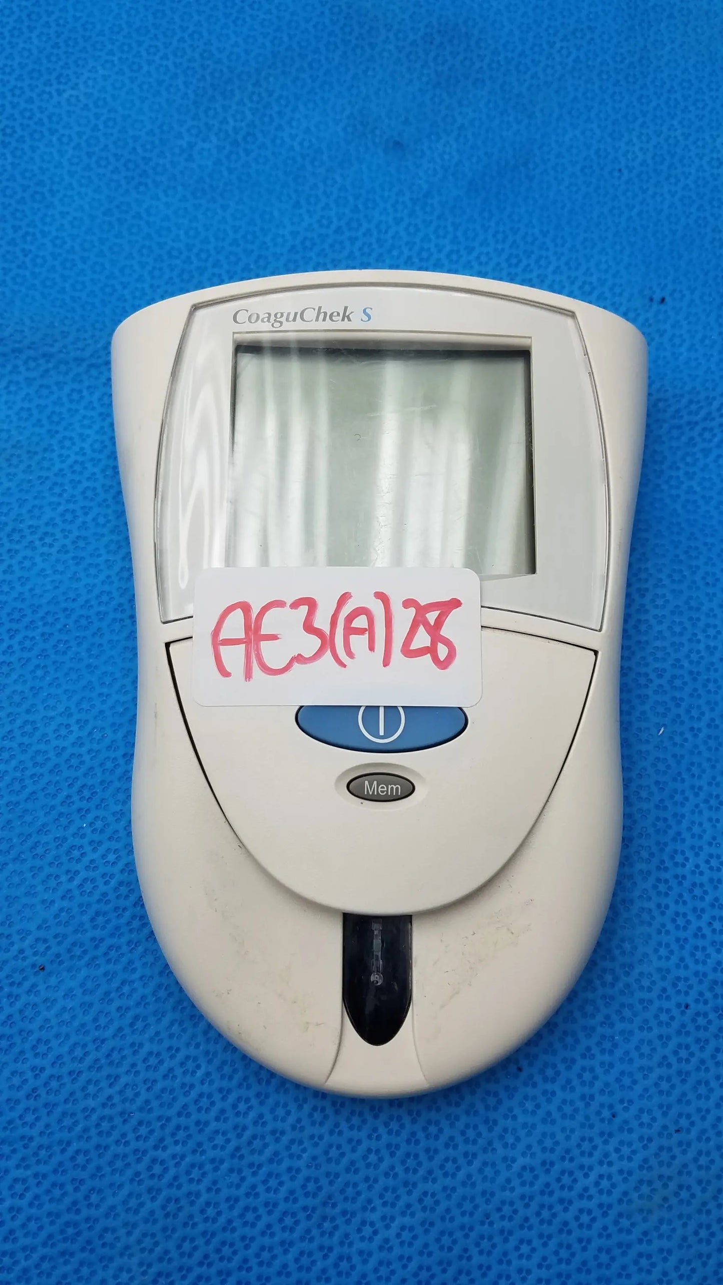 Roche CoaguChek S coagulation meter medical equipment with white case digital display and blue power button for reuse medical use