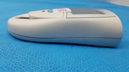 White plastic Roche CoaguChek S coagulation meter with small screen and test strip slot for reuse medical equipment use