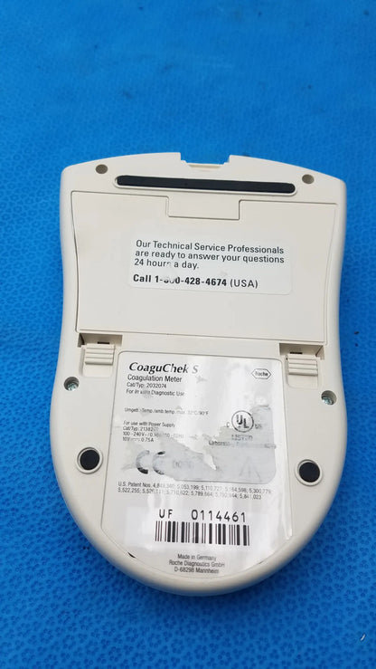 White Roche CoaguChek S coagulation meter back panel showing technical specifications for reuse medical equipment