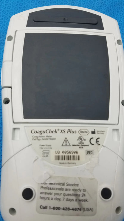 White roche coaguchek xs plus coagulation meter with black screen and gray plastic casing medical equipment model 04562780001