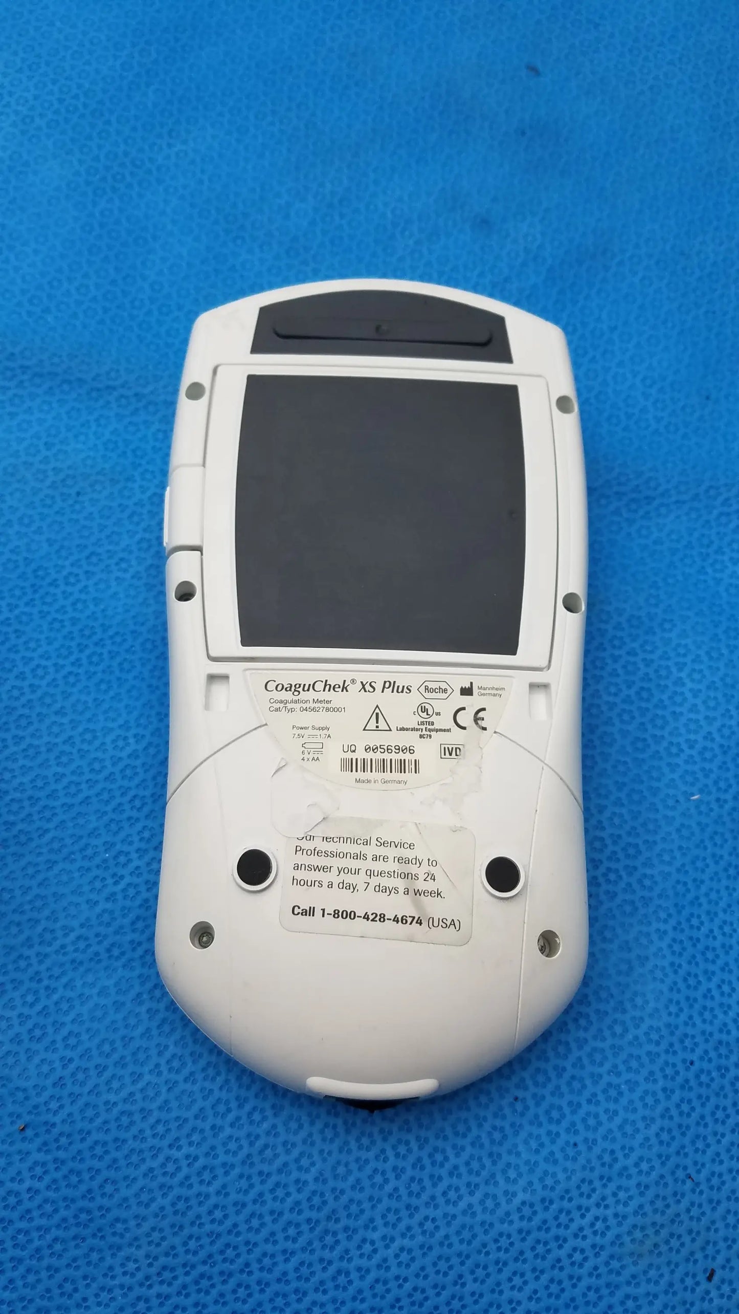 White Roche CoaguChek XS Plus coagulation meter medical equipment with black screen and rounded edges for blood testing