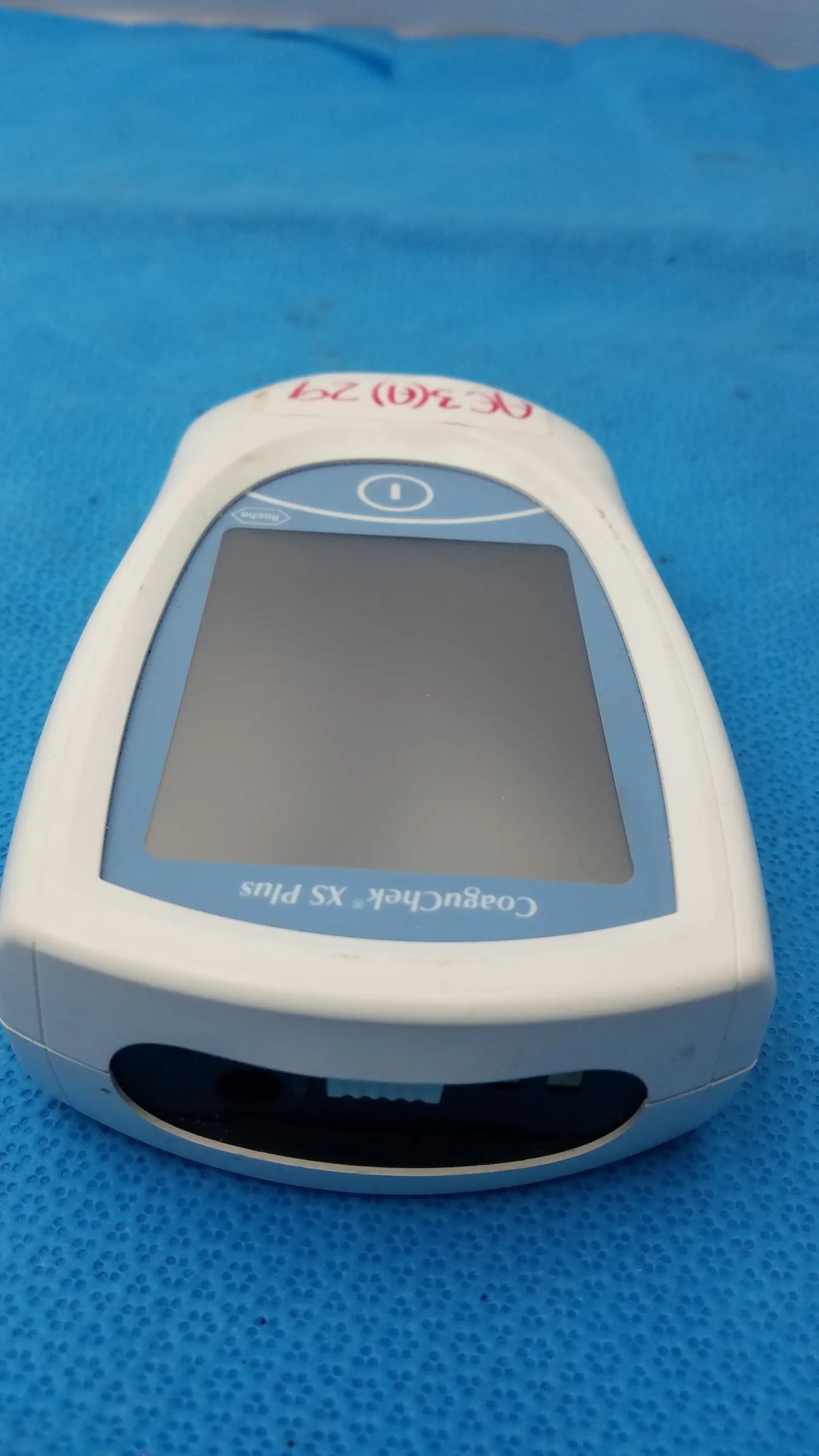 White and light blue roche coaguchek xs plus coagulation meter with rectangular screen for medical equipment use