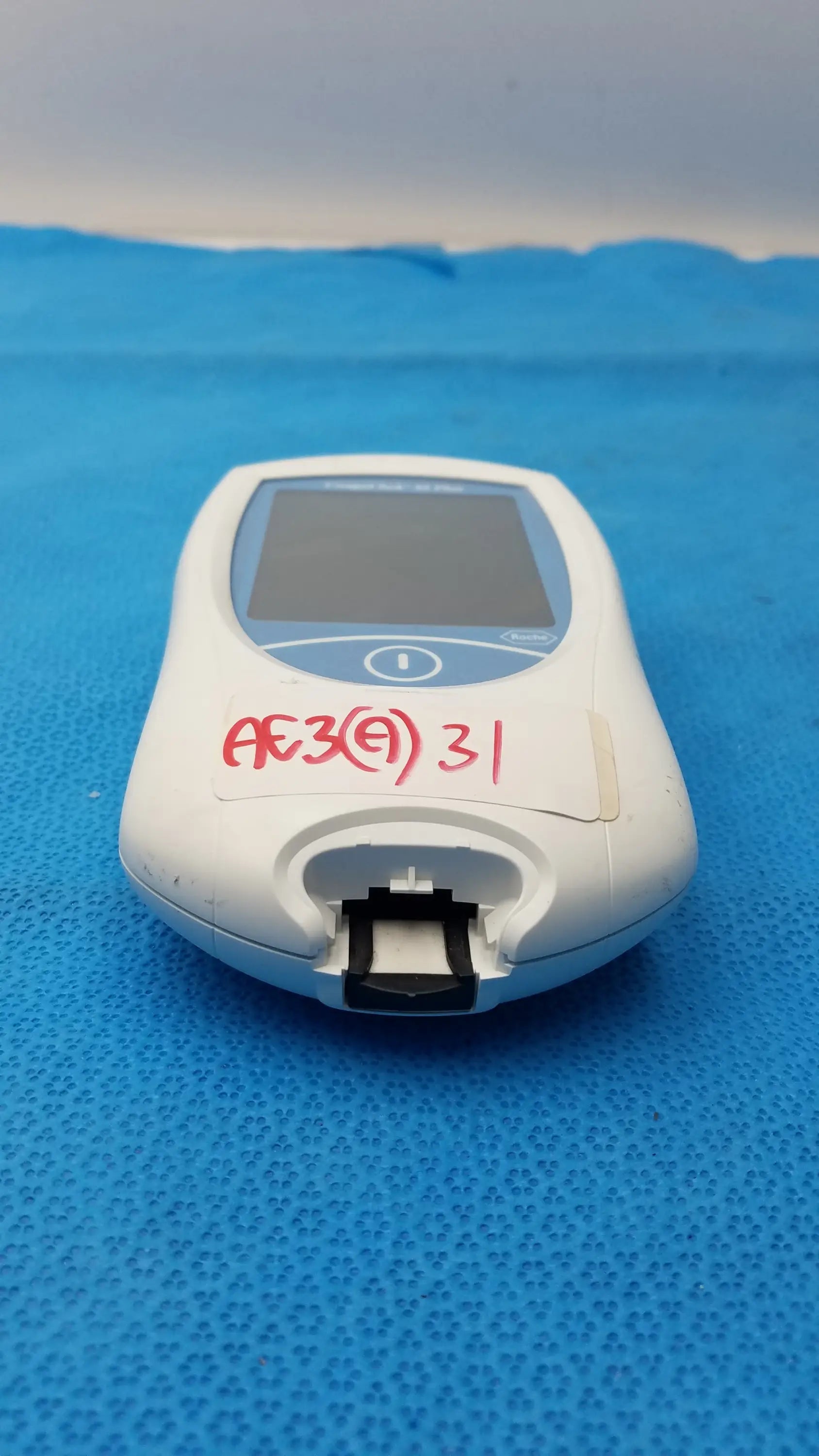 White plastic Roche CoaguChek XS Plus coagulation meter with small screen and black test strip slot for medical equipment use