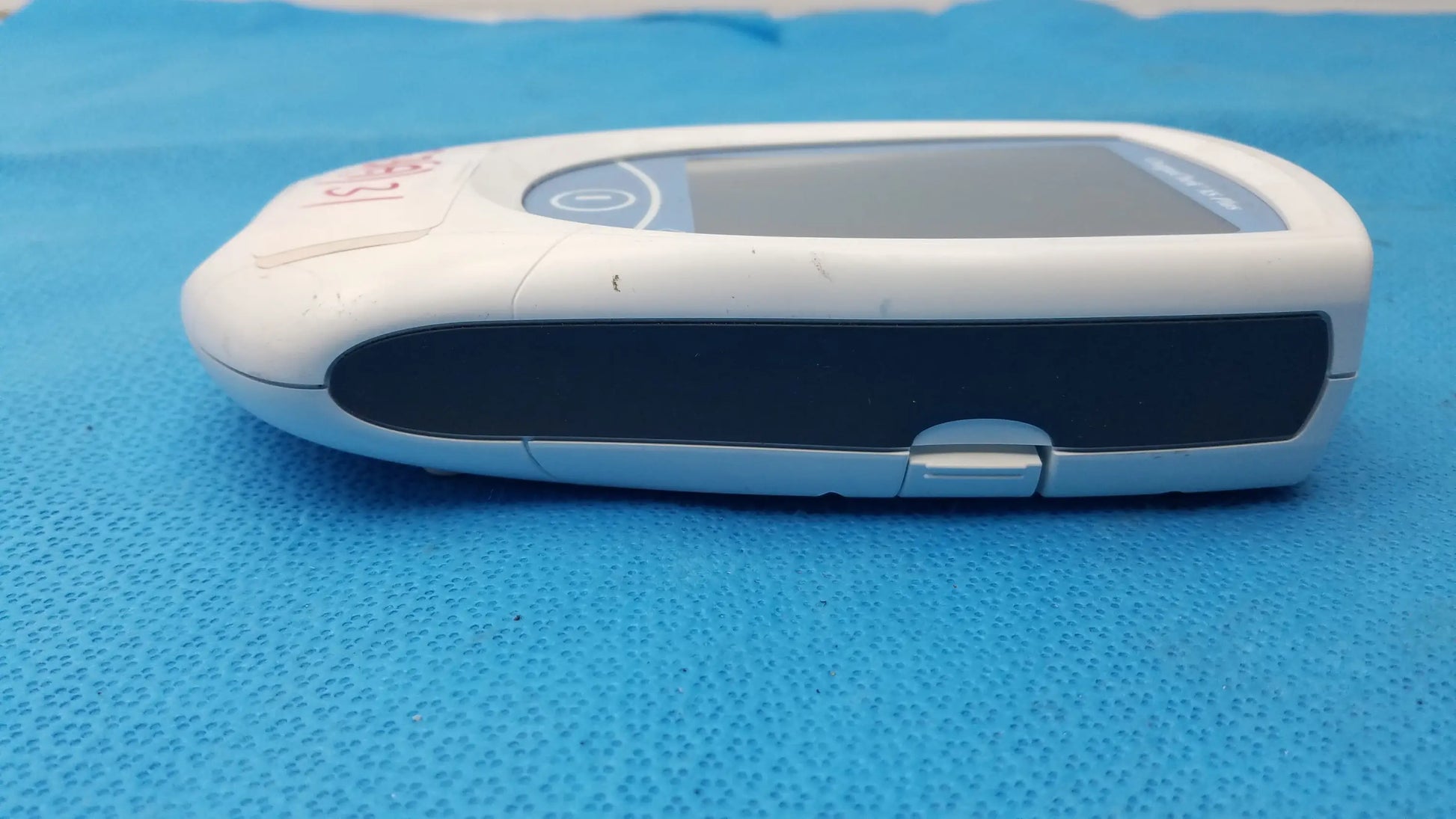 Roche coaguchek xs plus handheld glucose meter in white and black with sleek ergonomic design for medical equipment use