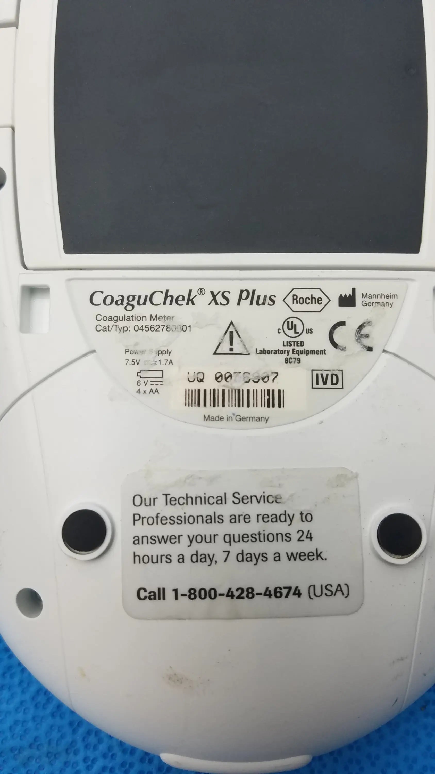 White roche coaguchek xs plus coagulation meter with matte finish showing labeled specifications on back panel of medical equipment