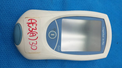 White and blue roche coaguchek xs plus coagulation meter medical equipment with digital screen by bruel & kjaer