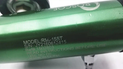 Green metallic cylindrical Roscoe medical mini oxygen regulator with engraved model and serial number markings on the back side