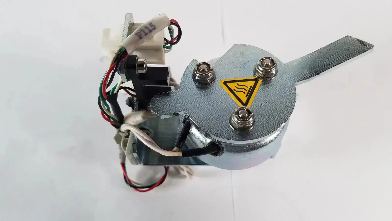 Silver metallic industrial motor with yellow warning triangle and four bolts securing casing for saia burgess ledex products hospital surplus