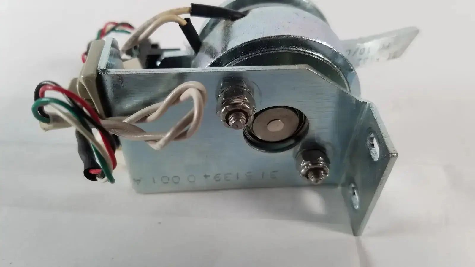 Silver-colored metal electrical solenoid with wiring and bracket from saia burgess ledex products hospital surplus