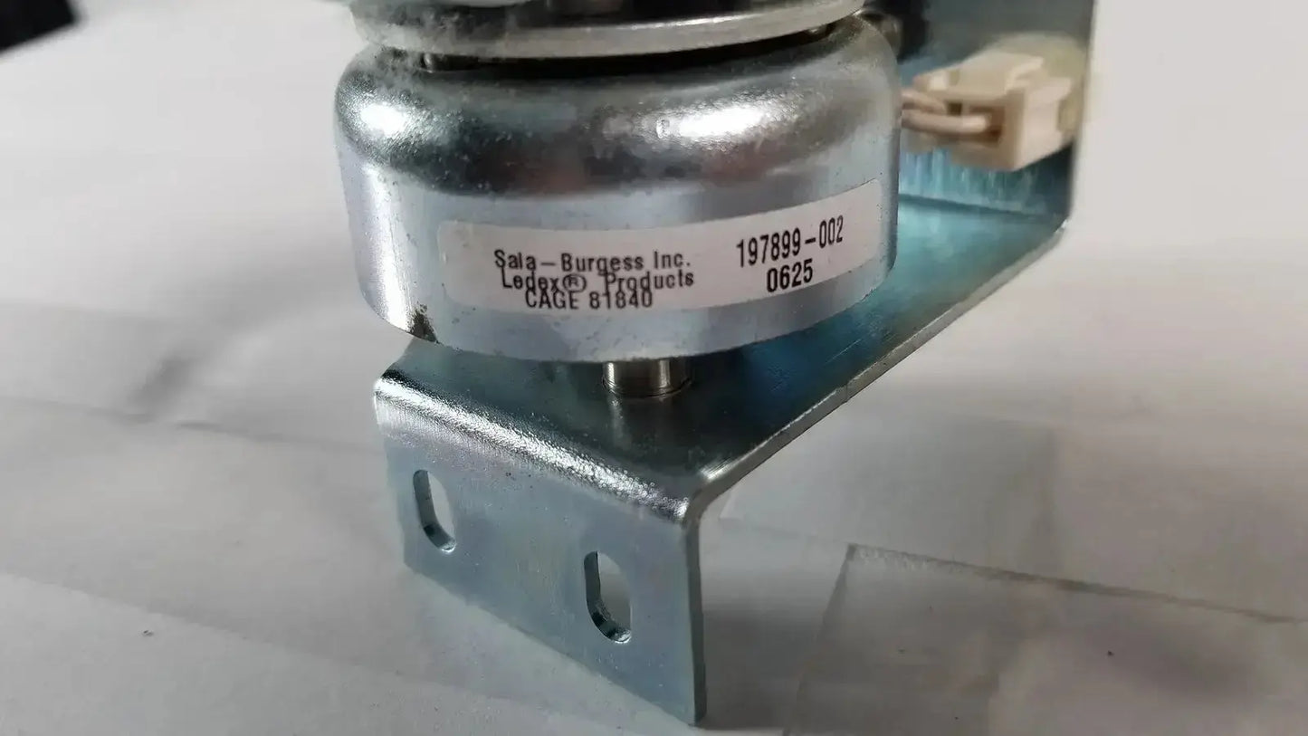 Silver metallic cylindrical solenoid valve saia burgess ledex products hospital surplus mounted on metal bracket with white label