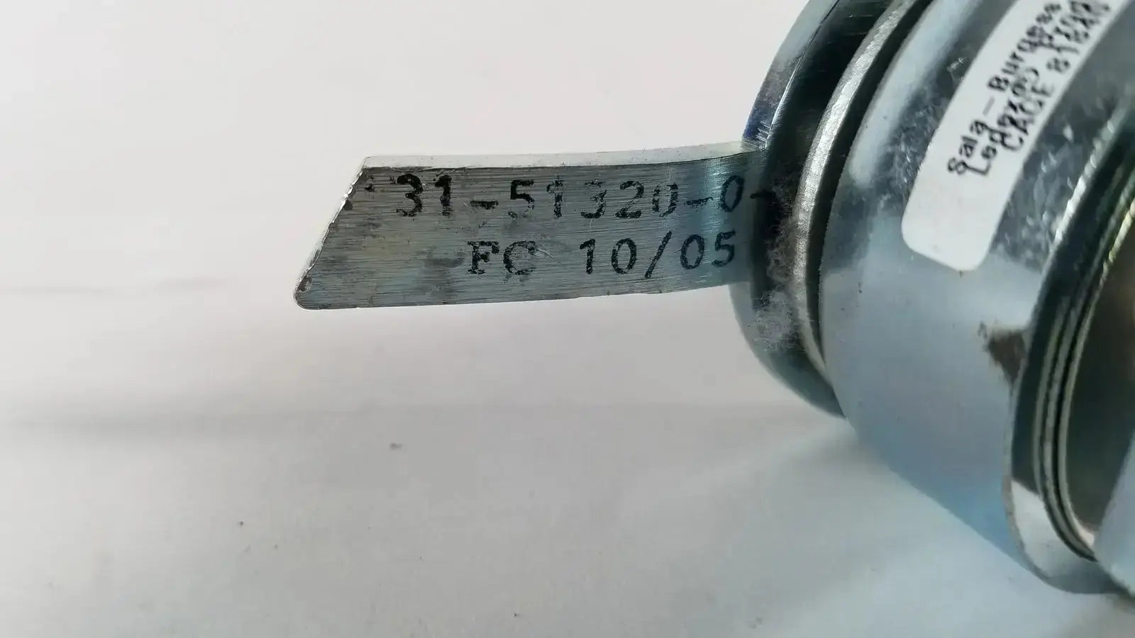 Metallic silver saia burgess cage tool with engraved markings and cylindrical handle from ledex products hospital surplus