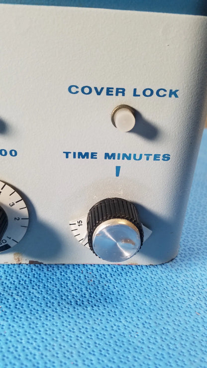 Light blue plastic control panel with time minutes knob and cover lock button on savant hsc 10k-115 high speed centrifuge medical equipment
