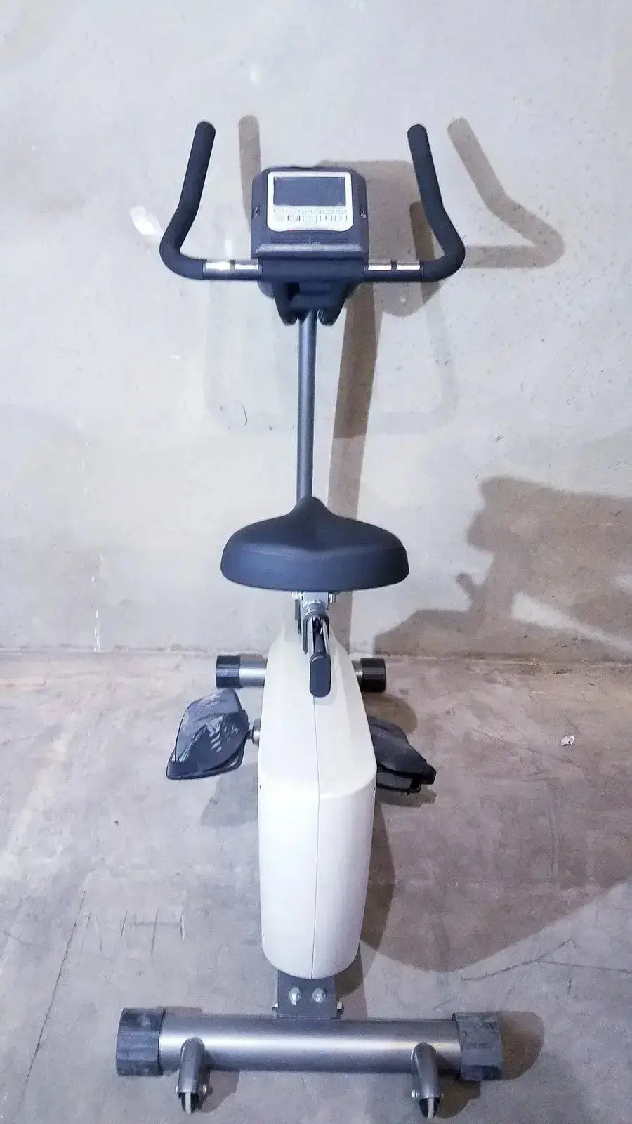 SciFit ISO 7000 upright exercise bike in black and white with digital display padded seat and adjustable handlebars