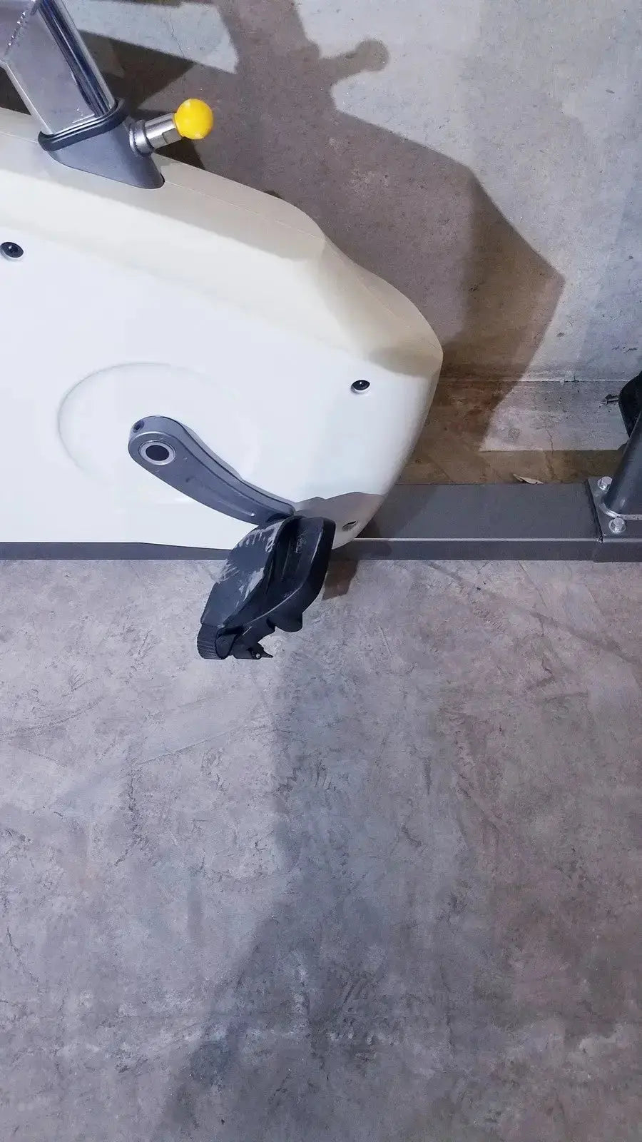 SciFit ISO 7000 upright exercise bike in white with black pedals and a yellow handle adjustment knob for upright exercise