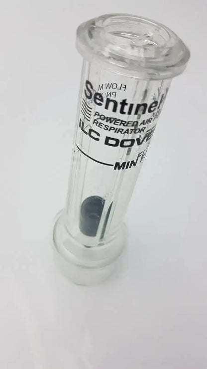 Clear plastic sentinel xl ilc dover min flow meter canister with black internal component and white labeling for respiratory use
