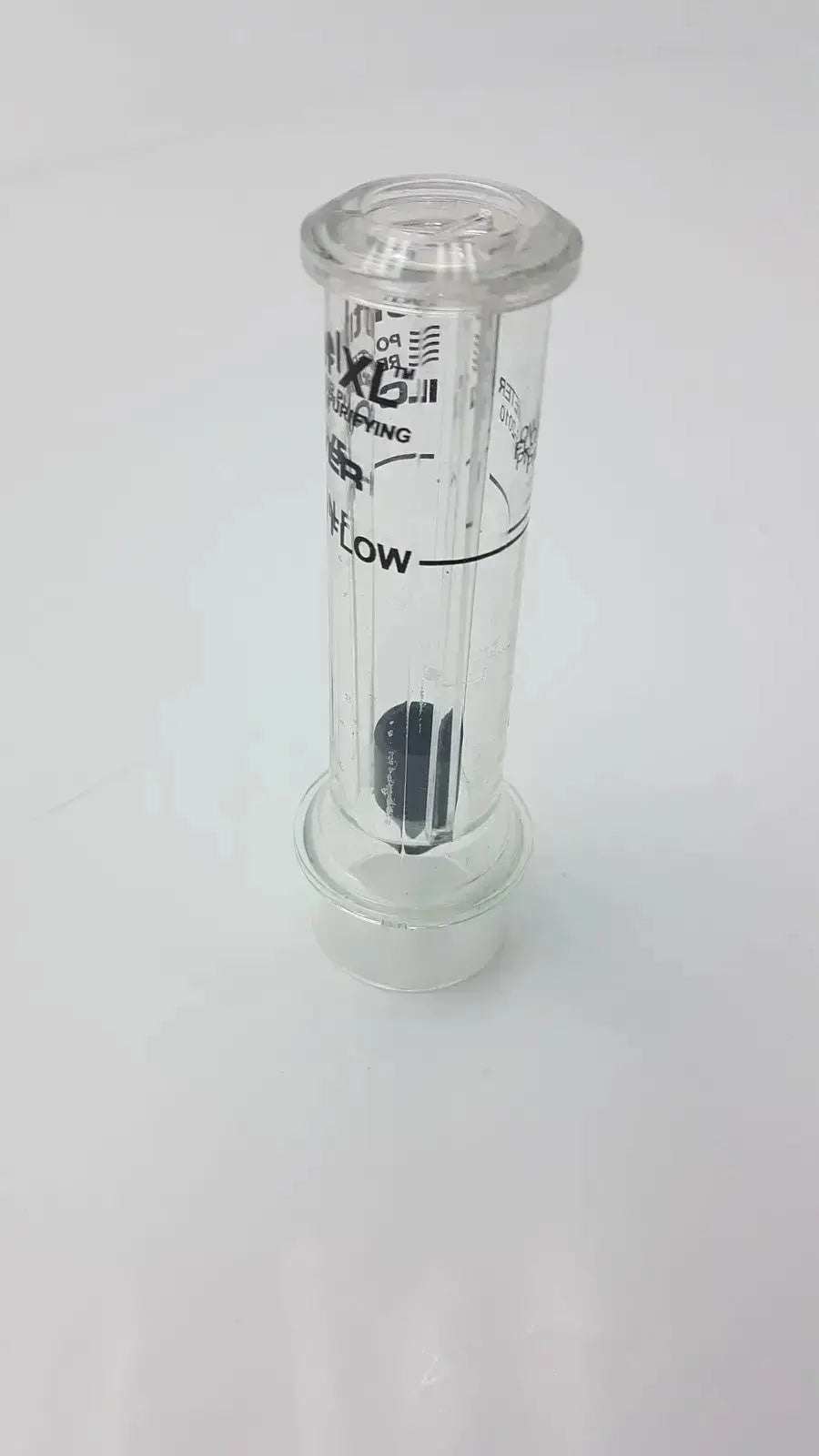 Clear cylindrical sentinel xl ilc dover min flow meter with black internal components and printed markings
