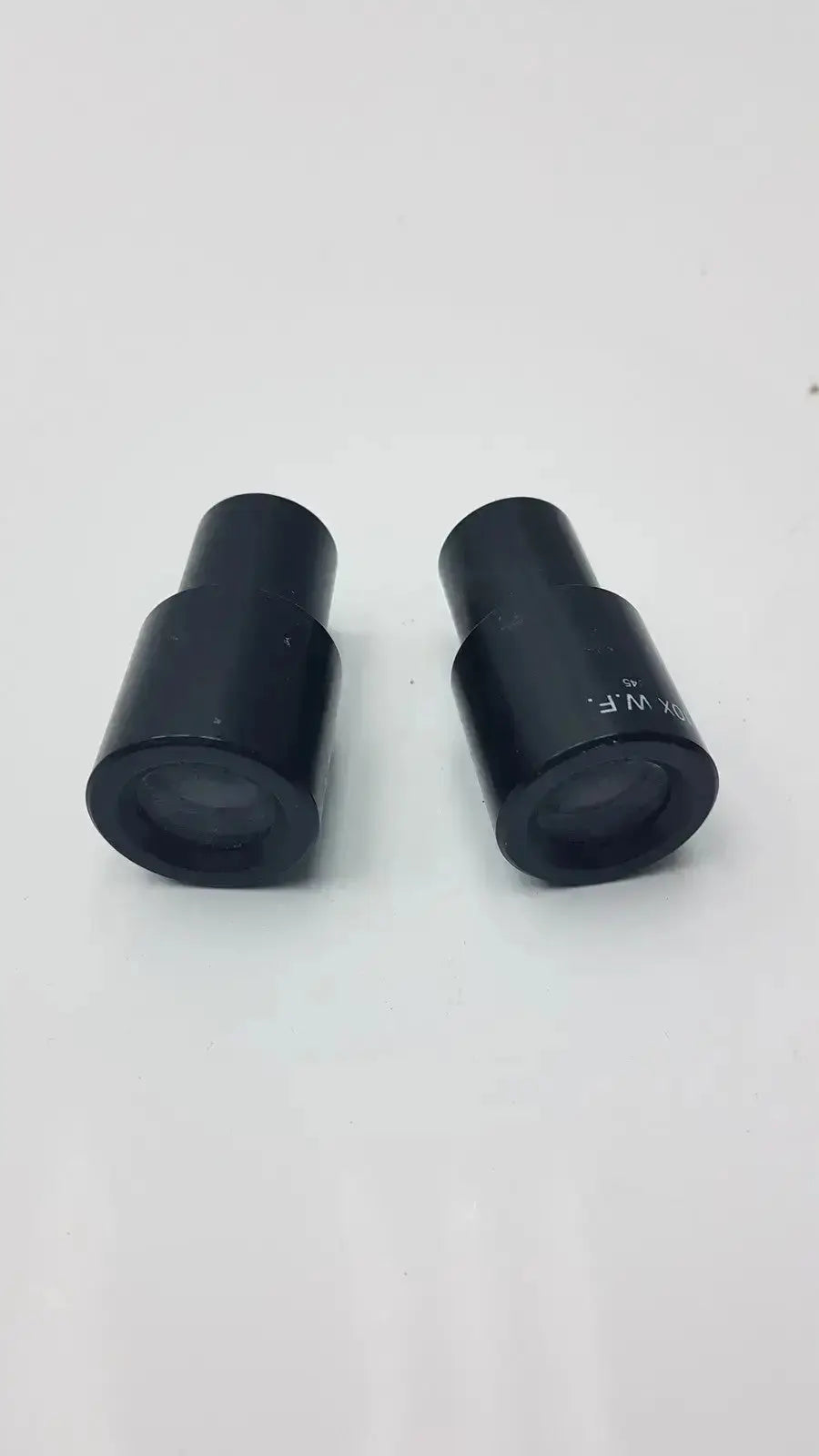 Set of 2 black cylindrical american optical 10x wide field microscope eyepieces with engraved markings cat 145