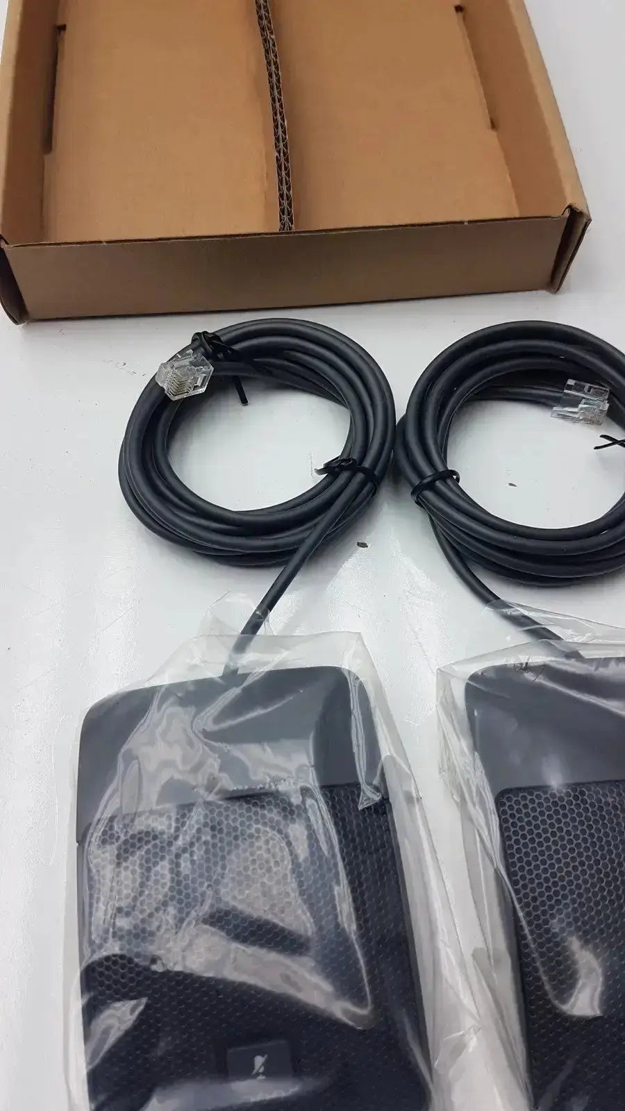 Set of 2 black mesh-covered wireless conference phone microphones in clear plastic packaging for Cisco UC phone hospital surplus