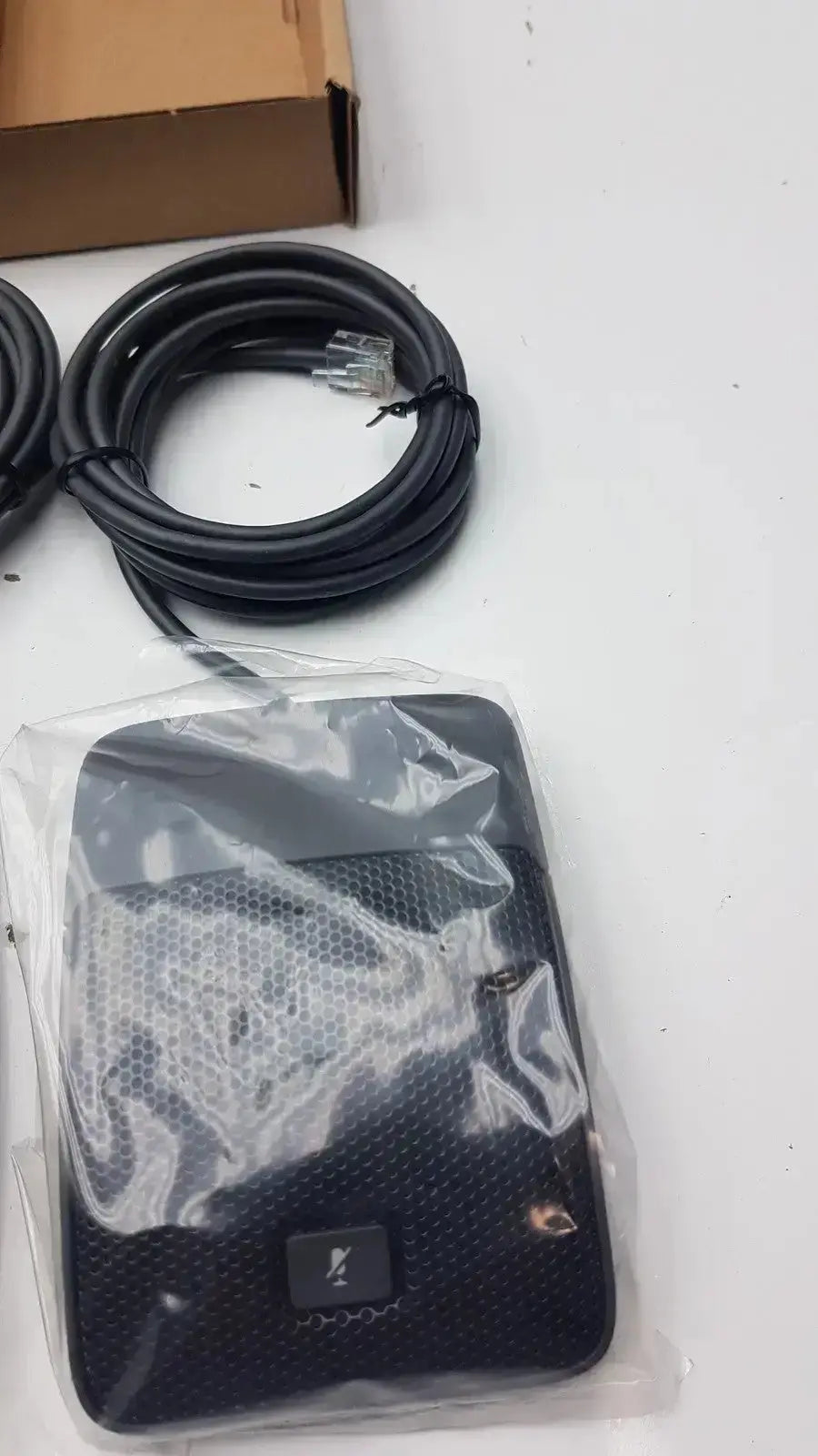 Black rectangular wireless router with textured surface and small logo, suitable for cisco uc phone conference phone microphone use